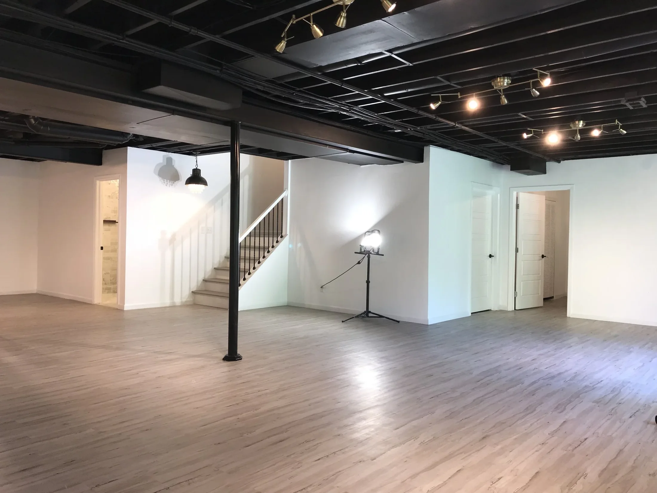 Finished basement with dark ceiling